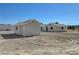 Several outbuildings under clear skies feature well-maintained white exteriors, creating a uniform appearance at 1450 Fern St, Pahrump, NV 89060