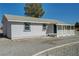 Charming single-story home boasting a covered front porch and desert landscaping, a rural retreat at 1450 Fern St, Pahrump, NV 89060