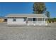 Lovely single-story home with a covered front porch and gravel landscaping for a desert escape at 1450 Fern St, Pahrump, NV 89060