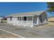 Quaint single-story home with a covered porch and gravel driveway offers a peaceful retreat at 1450 Fern St, Pahrump, NV 89060