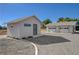 Exterior view of a charming detached outbuilding with gravel landscaping and a functional two-car garage at 1450 Fern St, Pahrump, NV 89060