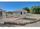 Exterior shot showcasing a pergola with brick pavers, nestled amongst tranquil landscaping, and adjacent to a functional garage at 1450 Fern St, Pahrump, NV 89060