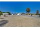 Single story home showcasing desert landscape, driveway and detached garage at 1450 Fern St, Pahrump, NV 89060
