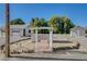 Wide exterior shot featuring a charming pergola, a functional garage, and a quaint outbuilding at 1450 Fern St, Pahrump, NV 89060