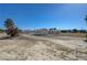 Wide view of the property featuring multiple detached buildings on a spacious lot at 1450 Fern St, Pahrump, NV 89060