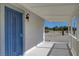 A lovely entryway with a blue door, porch, and outdoor lighting creates an inviting welcome at 1450 Fern St, Pahrump, NV 89060