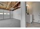 Spacious garage features an unfinished ceiling with exposed wood rafters, a concrete floor, and a functional utility sink at 1450 Fern St, Pahrump, NV 89060