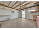 Spacious garage featuring wood beam ceiling, wooden floors, custom cabinets, and a convenient work table at 1450 Fern St, Pahrump, NV 89060