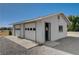 Garage includes dual doors, entry door and concrete apron at 1450 Fern St, Pahrump, NV 89060