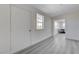 Hallway with light gray wood floors and a glimpse of the formal dining room with seating for four at 1450 Fern St, Pahrump, NV 89060