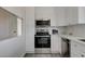 Bright kitchen with stainless steel appliances, white cabinets and tile backsplash, providing a modern and clean cooking space at 1450 Fern St, Pahrump, NV 89060