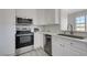 Kitchen with stainless steel appliances, white cabinetry and granite countertops at 1450 Fern St, Pahrump, NV 89060