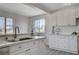 Bright kitchen with stainless steel faucet, durable countertops and dual windows for natural light at 1450 Fern St, Pahrump, NV 89060
