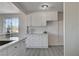 White cabinetry with modern hardware provides ample storage in this freshly painted kitchen with durable flooring at 1450 Fern St, Pahrump, NV 89060