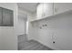 A well-lit laundry room with modern fixtures and plenty of storage cabinets at 1450 Fern St, Pahrump, NV 89060