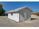 Outbuilding with new gray roof, window, exterior door, and concrete approach in the backyard at 1450 Fern St, Pahrump, NV 89060