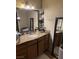 Bathroom featuring granite countertop, neutral tone walls, and ample storage at 1455 E Katie Ave # L23, Las Vegas, NV 89119
