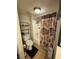 A full bathroom features shower and tub combo with shower curtain, and shelving for storage at 1455 E Katie Ave # L23, Las Vegas, NV 89119