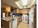 Traditional kitchen featuring wood cabinetry, granite countertops and white appliances at 1455 E Katie Ave # L23, Las Vegas, NV 89119