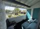 A cozy patio furnished with comfortable seating overlooks a community tennis court and green space at 1455 E Katie Ave # L23, Las Vegas, NV 89119