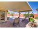 Outdoor patio area with comfortable seating, lush greenery, a sparkling pool, and bright blue sky at 1766 Baja Ln, Henderson, NV 89012