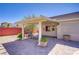 Outdoor patio area with comfortable seating, lush greenery, and bright blue sky at 1766 Baja Ln, Henderson, NV 89012