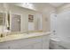 Well-lit bathroom featuring a granite countertop, white cabinetry, and a combined shower-tub, designed for comfort and practicality at 1766 Baja Ln, Henderson, NV 89012