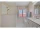Modern bathroom showcasing a glass-enclosed shower and dual sink vanity at 1766 Baja Ln, Henderson, NV 89012