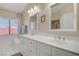 Bright bathroom featuring double sinks, a bathtub, and a window providing natural light at 1766 Baja Ln, Henderson, NV 89012