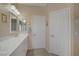 Bright bathroom featuring double sinks with vanity, a large mirror, and modern lighting at 1766 Baja Ln, Henderson, NV 89012