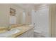 Clean bathroom design boasting a granite countertop, white fixtures, and shower-tub, providing a fresh and functional space at 1766 Baja Ln, Henderson, NV 89012