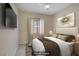 Inviting bedroom with a comfortable bed, neutral tones, and stylish decor at 1766 Baja Ln, Henderson, NV 89012