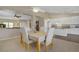 Bright dining room featuring a neutral color palette, ceiling fan, and seamless access to the kitchen and living spaces at 1766 Baja Ln, Henderson, NV 89012