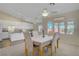 Sunlit dining area with a neutral color palette complemented by white trim and seamless transition to a modern kitchen at 1766 Baja Ln, Henderson, NV 89012