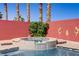 Hot tub with tiled exterior and swan fountain feature surrounded by red brick privacy wall at 1766 Baja Ln, Henderson, NV 89012
