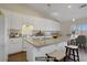 Bright kitchen featuring white cabinets, granite countertops, and an island with seating at 1766 Baja Ln, Henderson, NV 89012