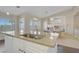 Open concept kitchen with granite countertops, a large island, and a seamless transition to the dining and living areas at 1766 Baja Ln, Henderson, NV 89012