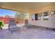 Covered patio with lounge chairs and brick-paved floor, perfect for outdoor relaxation at 1766 Baja Ln, Henderson, NV 89012