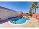Sparkling in-ground pool featuring a hot tub, lush greenery, and bright blue sky at 1766 Baja Ln, Henderson, NV 89012