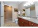 Well-lit bathroom featuring granite countertops and walk-in closet access at 2120 Ramrod Ave # 513, Henderson, NV 89014