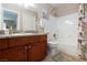 Well-lit bathroom with granite countertop, wooden cabinets, shower and tub combination at 2120 Ramrod Ave # 513, Henderson, NV 89014