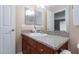 Bathroom showcasing a granite countertop, wooden cabinets, and a well-lit mirror at 2120 Ramrod Ave # 513, Henderson, NV 89014