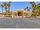 Attractive clubhouse exterior with palm trees, lush landscaping, and well-maintained grounds at 2120 Ramrod Ave # 513, Henderson, NV 89014