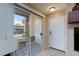 Bright entrance with a sliding glass door leading to a balcony with comfortable seating at 2120 Ramrod Ave # 513, Henderson, NV 89014