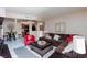 Inviting living room featuring a comfortable brown sectional sofa and bright red accent chair at 2120 Ramrod Ave # 513, Henderson, NV 89014