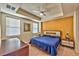 Bright bedroom featuring tray ceilings, large windows, and decorative lamps at 2405 W Serene Ave # 703, Las Vegas, NV 89123