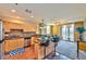 Modern kitchen with granite countertops, stainless steel appliances, breakfast bar, and access to a balcony at 2405 W Serene Ave # 703, Las Vegas, NV 89123