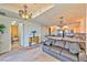 Inviting living area with open floor plan, chandelier lighting, comfortable seating, and kitchen access at 2405 W Serene Ave # 703, Las Vegas, NV 89123