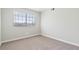 Bright bedroom with a large window and neutral carpet at 2750 S Durango Dr # 2061, Las Vegas, NV 89117