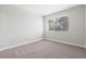 Cozy bedroom featuring neutral walls and carpet and a large window at 2750 S Durango Dr # 2061, Las Vegas, NV 89117
